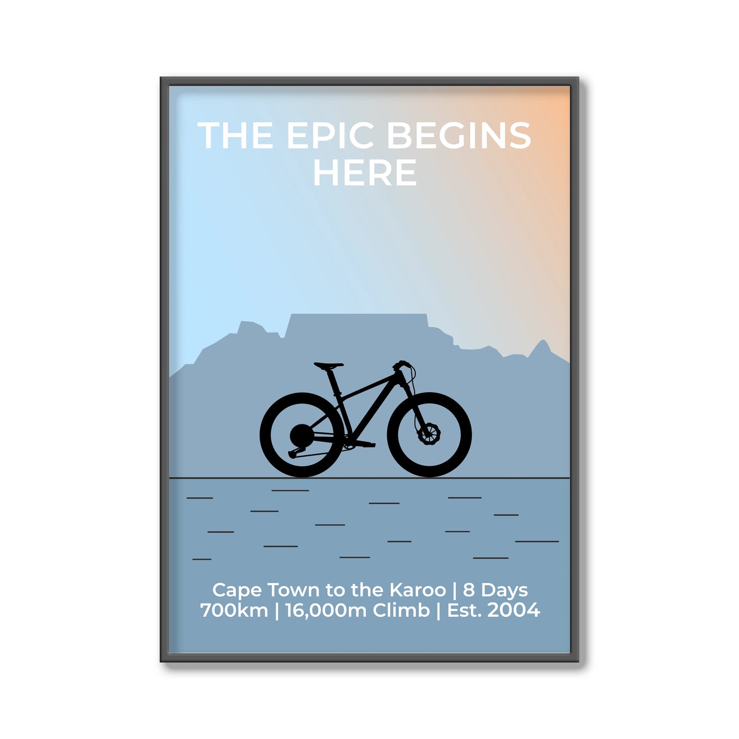 Framed poster with a bicycle silhouette, mountain landscape, and text about a cycling journey.